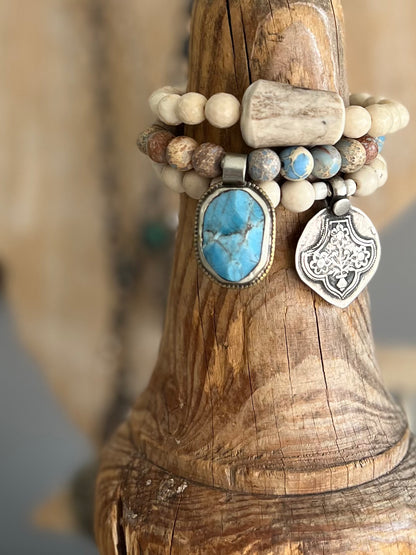 Tibetan turquoise pendant surrounded by sea sediment Jasper. Stretch bracelet 6.5” (small wrist).