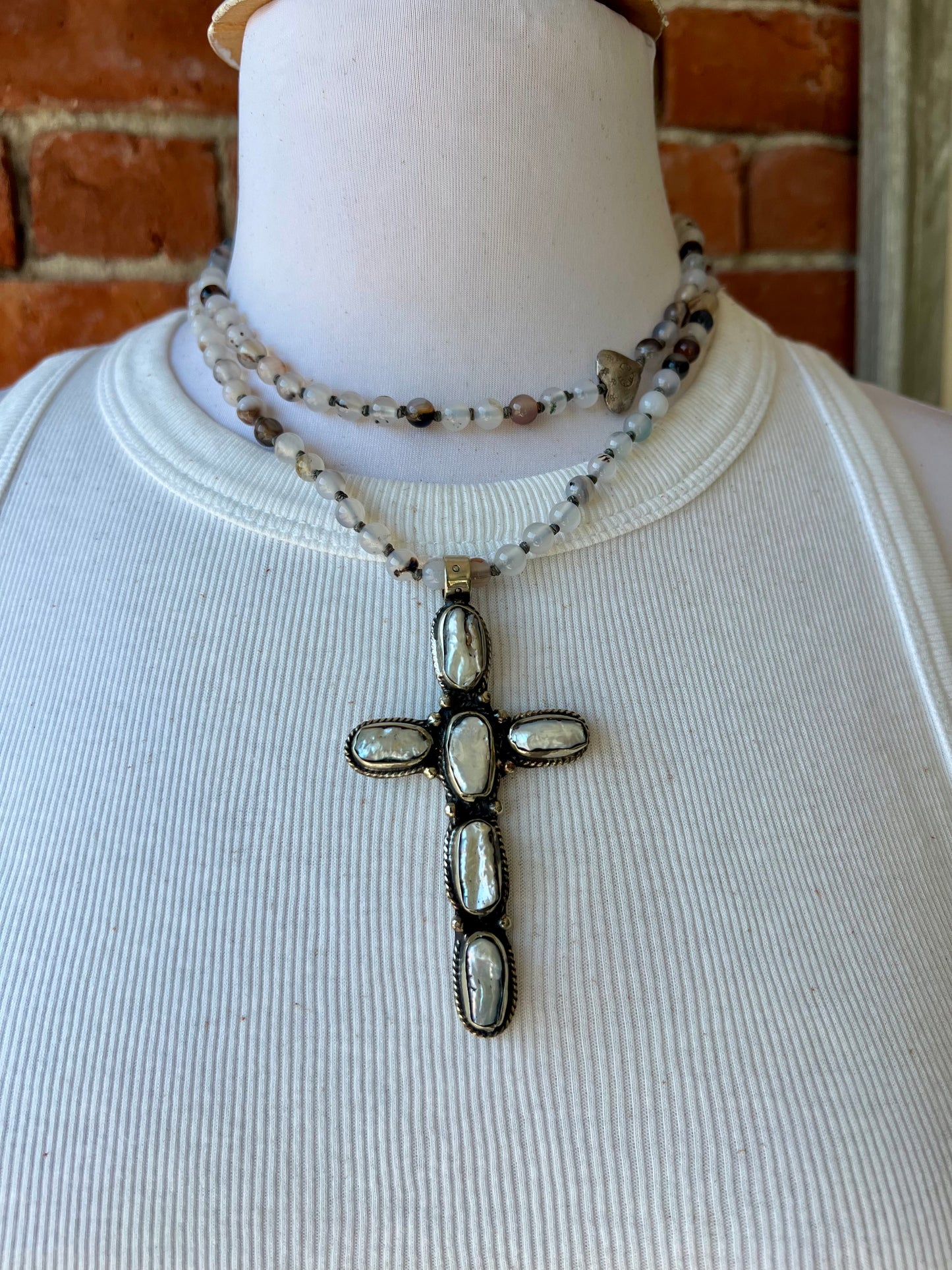 Pearl cross on knotted agates with fine silver heart accent. 44” necklace.