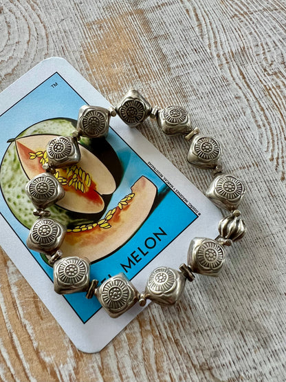 Stamped fine silver flower stretch bracelet.