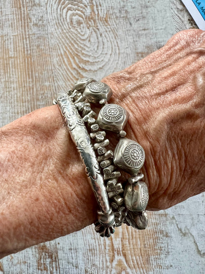 Stamped fine silver flower stretch bracelet.