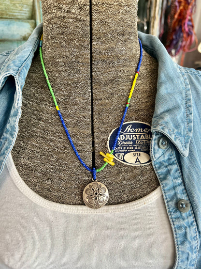 Stamped Thai pendant with colorful Java glass seed beads necklace.