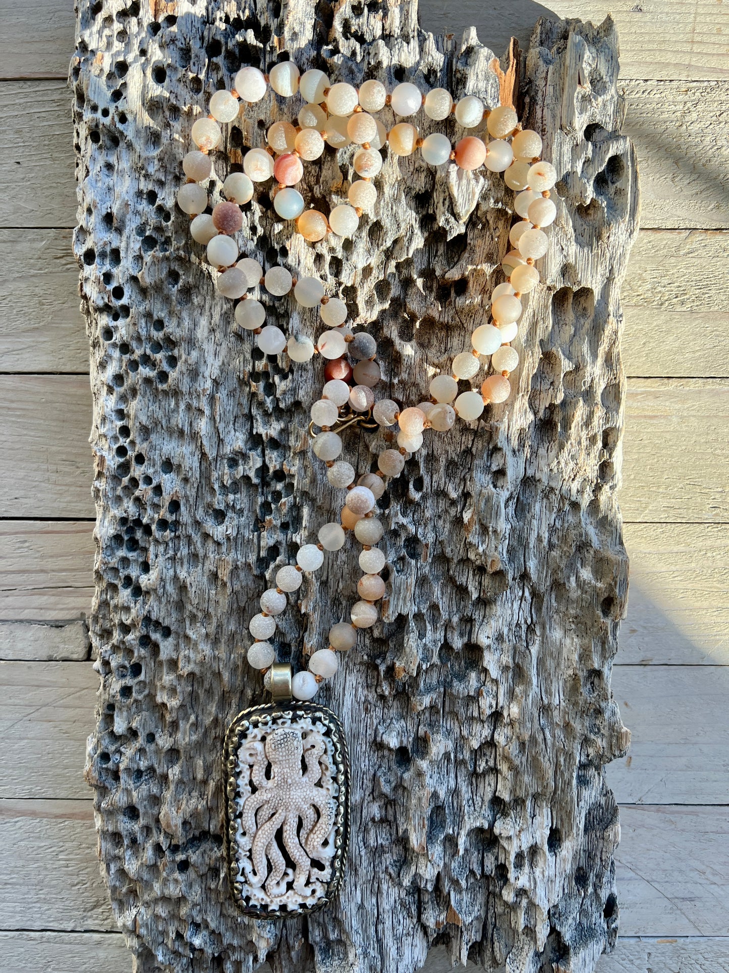 Carved bone octopus on hand-knotted druzy agates.  39” necklace. Wear long or short.