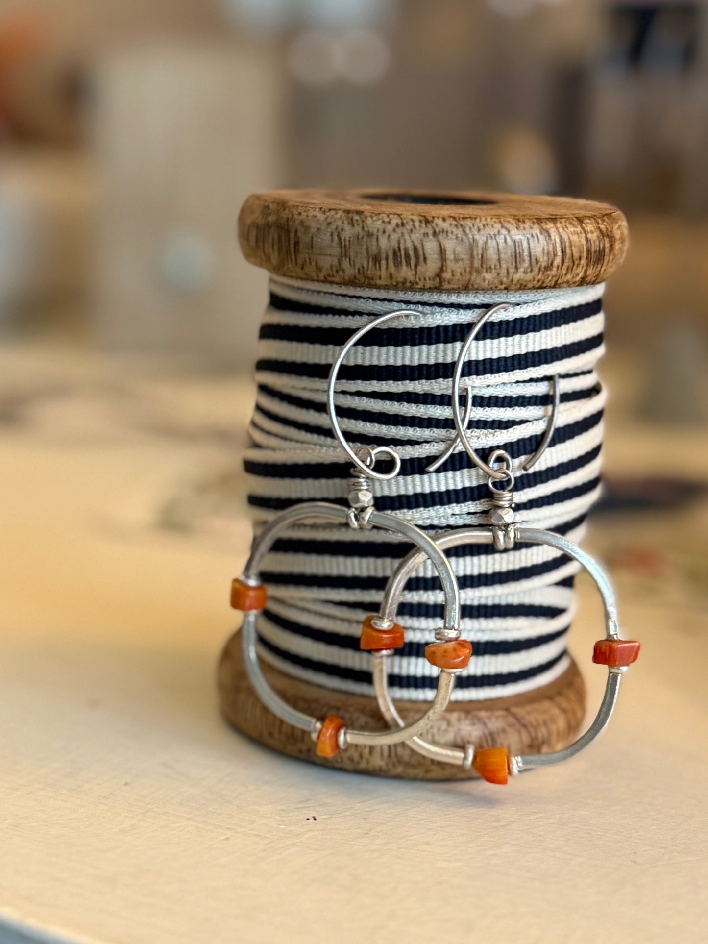 Segmented hoops of fine silver with broom coral accents earrings.