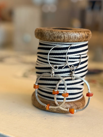 Segmented hoops of fine silver with broom coral accents earrings.