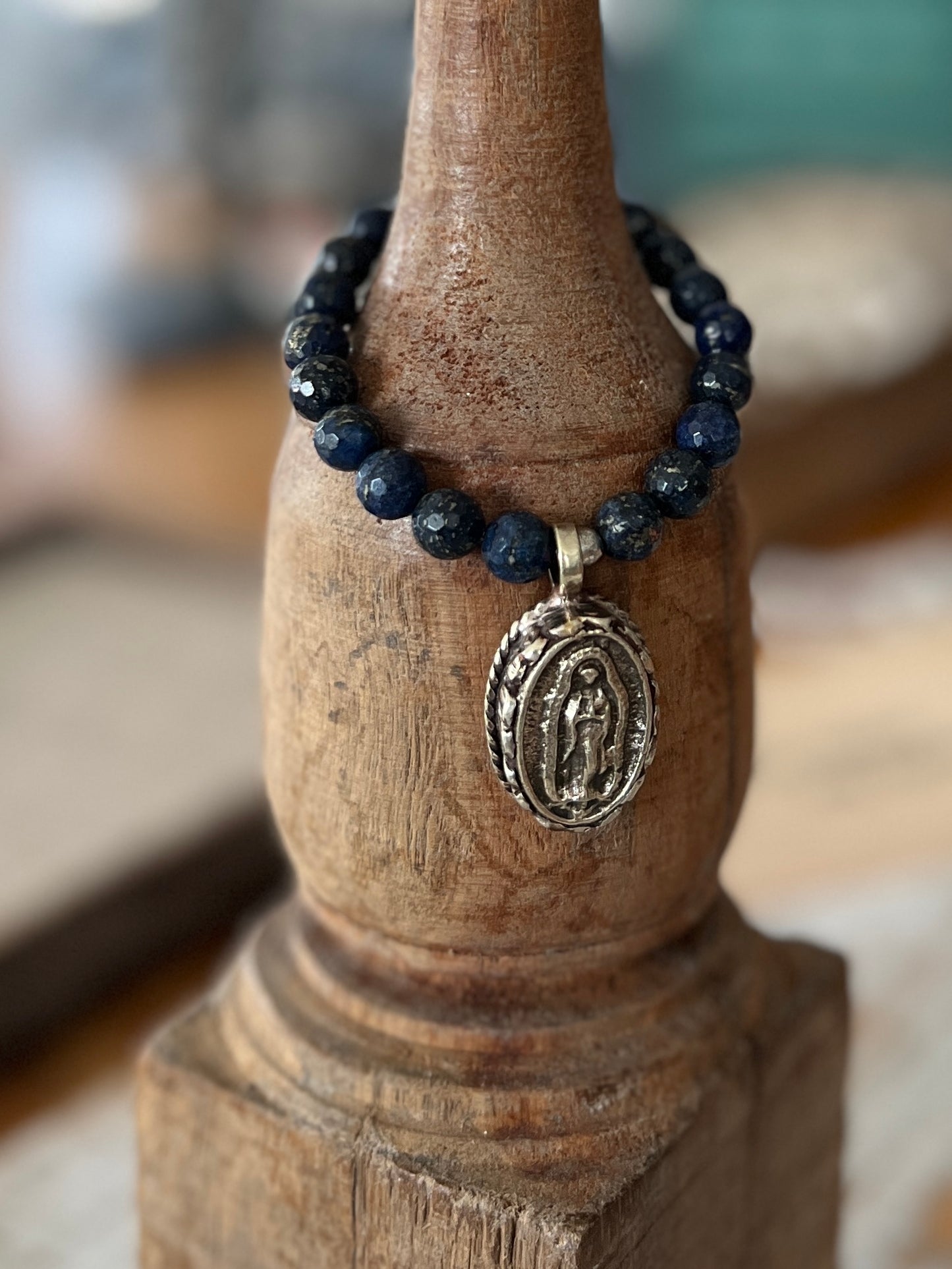 Faceted lapis beads surround a beautiful Tibetan repousé Mary. Stretch stacker bracelet 6-6.5”