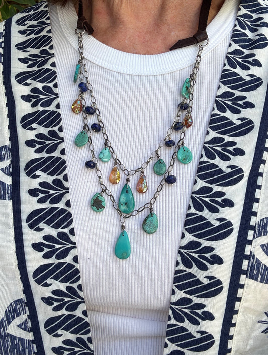 Turquoise, carnelian, and lapis necklace on sterling chain. All suspended from deerskin leather and adjustable from  15-30”.
