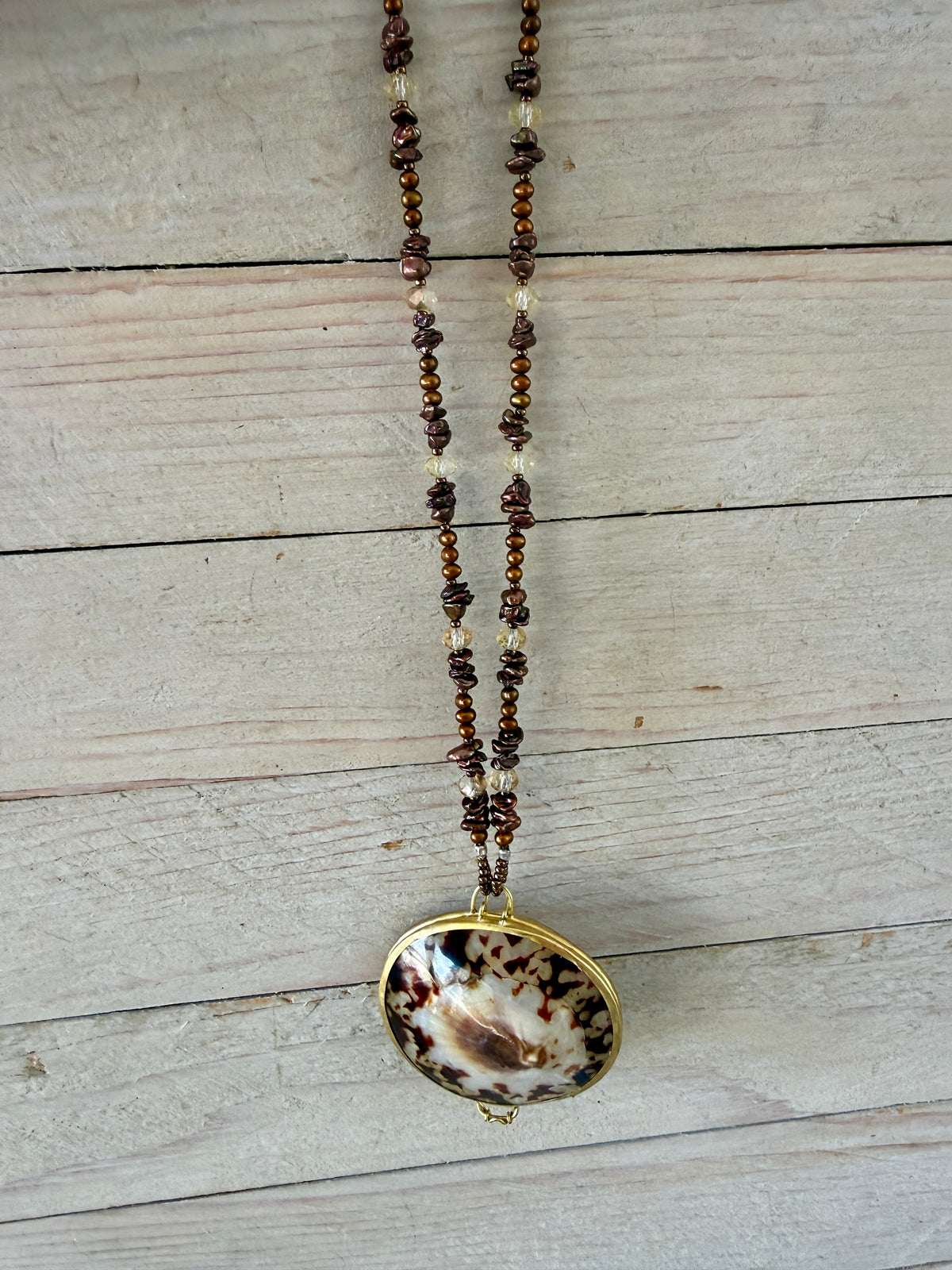 Shell “purse” on brown pearls and Czech glass necklace.