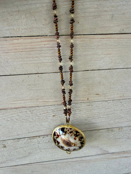 Shell “purse” on brown pearls and Czech glass necklace.