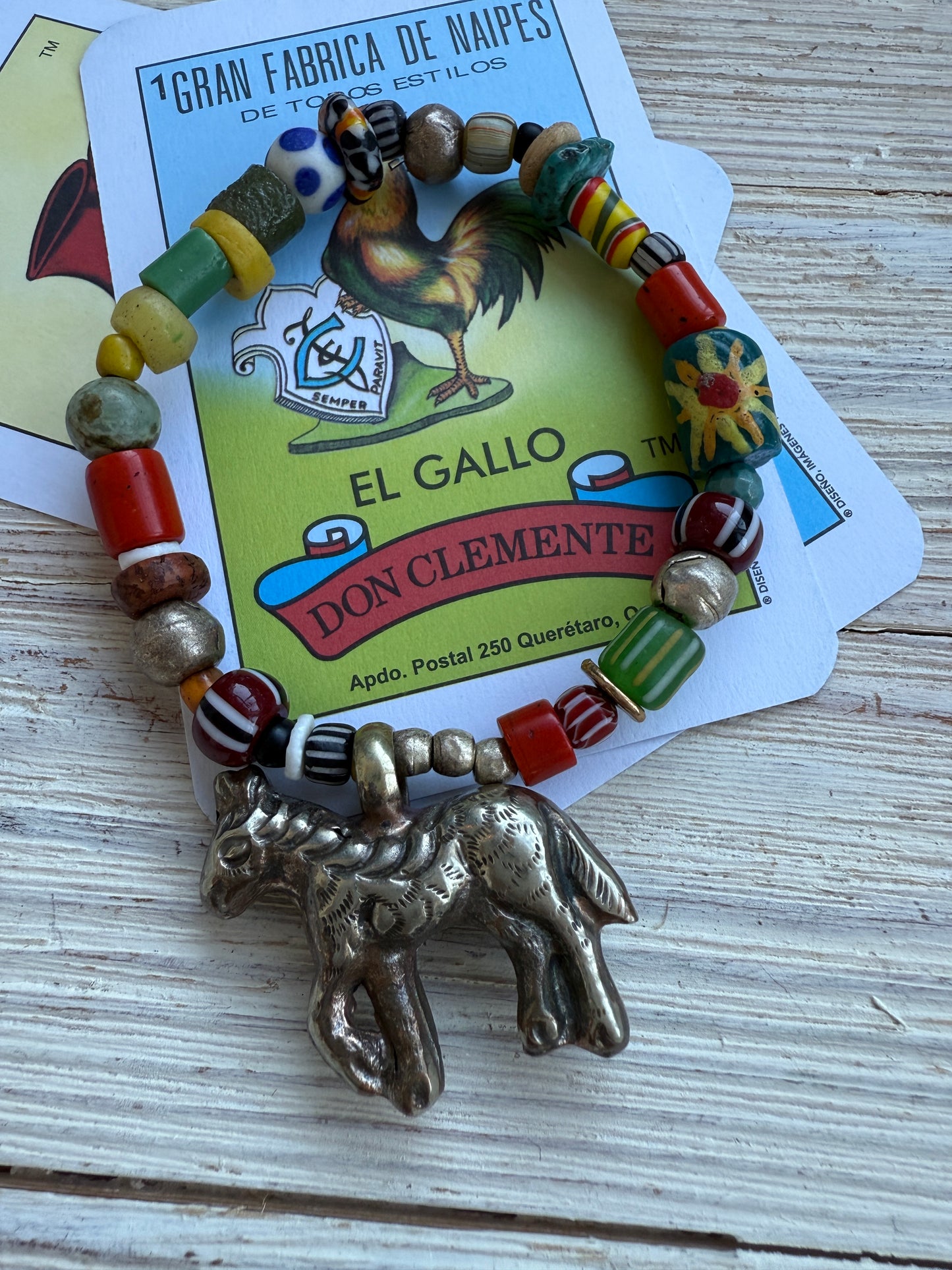 Donkey charm on a mix of gems, trade beads, and Ethiopian silver stretch bracelet. 6.5”