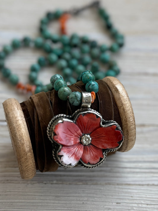 Spiny oyster flower pendant from Tibet on knotted turquoise with spiny oyster accents. 34” long necklace.