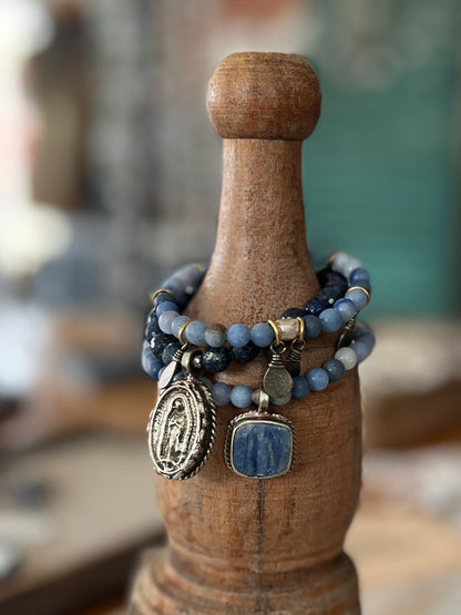 Tibetan blue kyanite pendant suspended from matte blue aventurine stack stretch bracelet. 7”