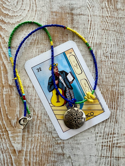 Stamped Thai pendant with colorful Java glass seed beads necklace.