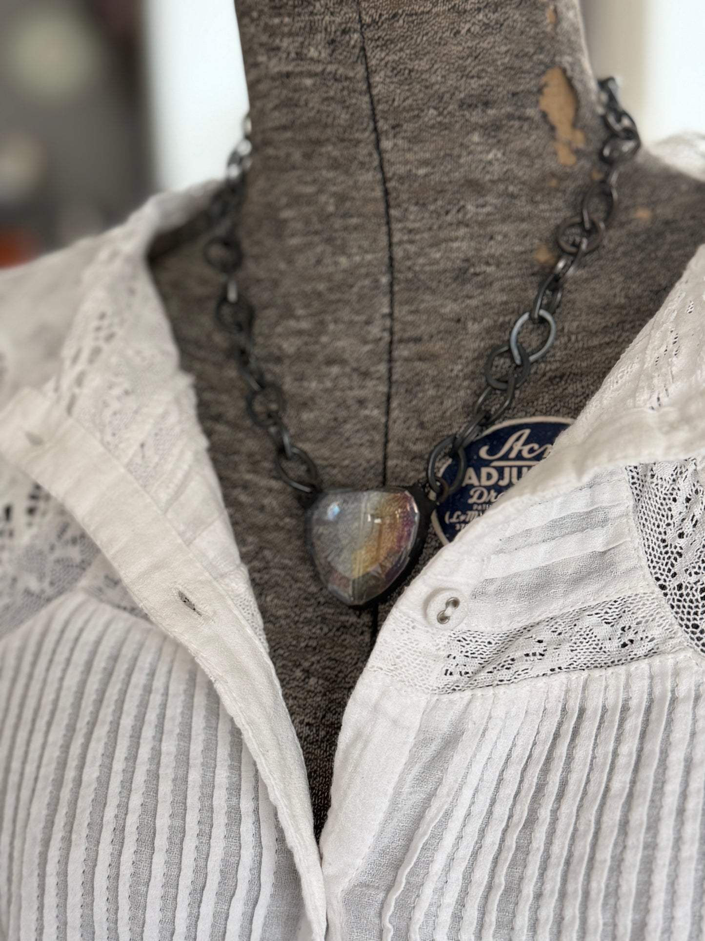 Prism crystal heart on gunmetal base metal chain necklace.