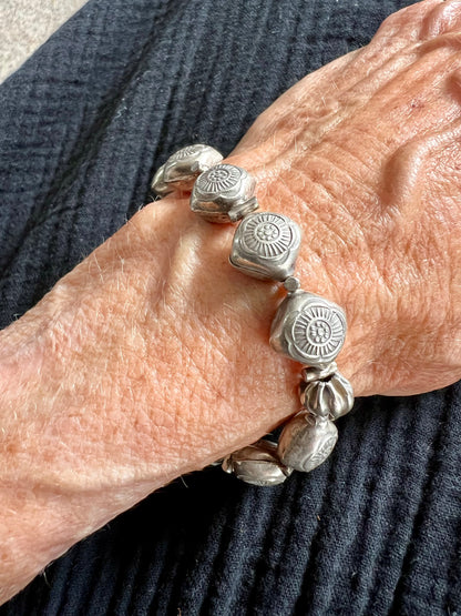 Stamped fine silver flower stretch bracelet.