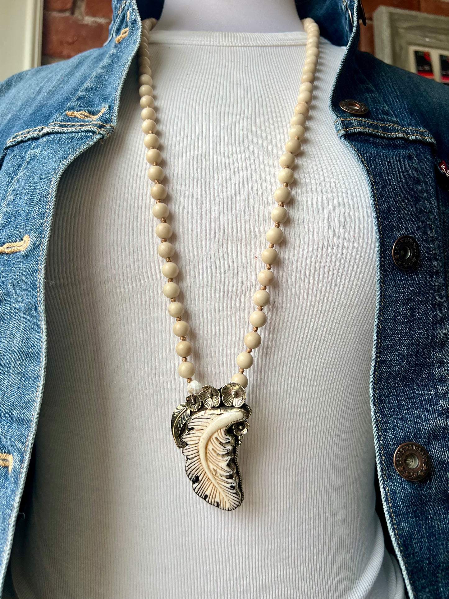 Bone feather on riverstone long boho necklace.