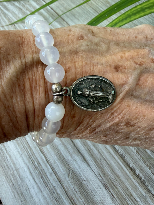 Miraculous medal on white quartz beads stretch bracelet. 6”