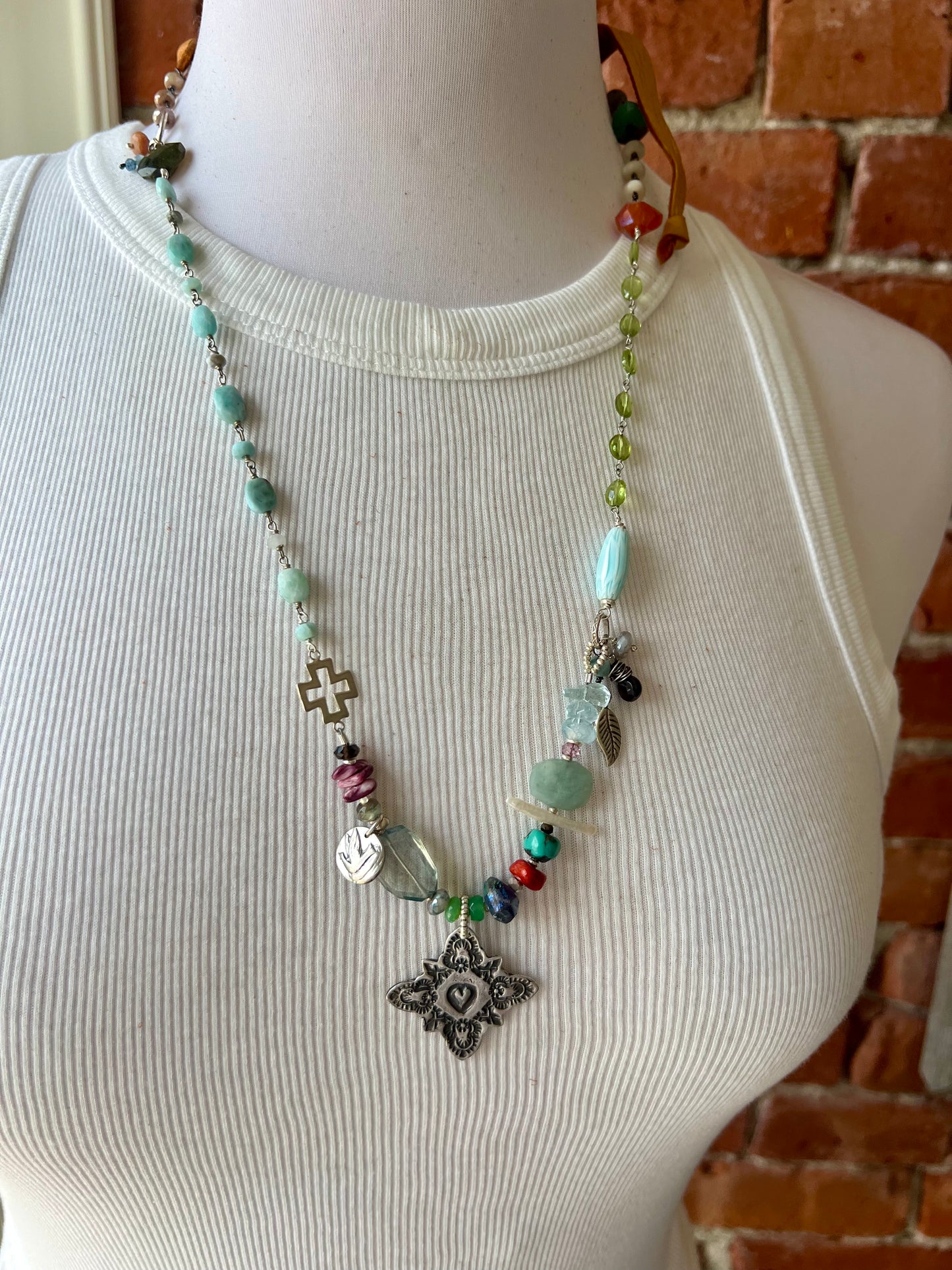 Stamped sterling silver heart pendant surrounded by a calming mix of gemstones necklace.