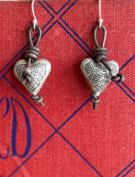 Stamped fine silver hearts on leather earrings.