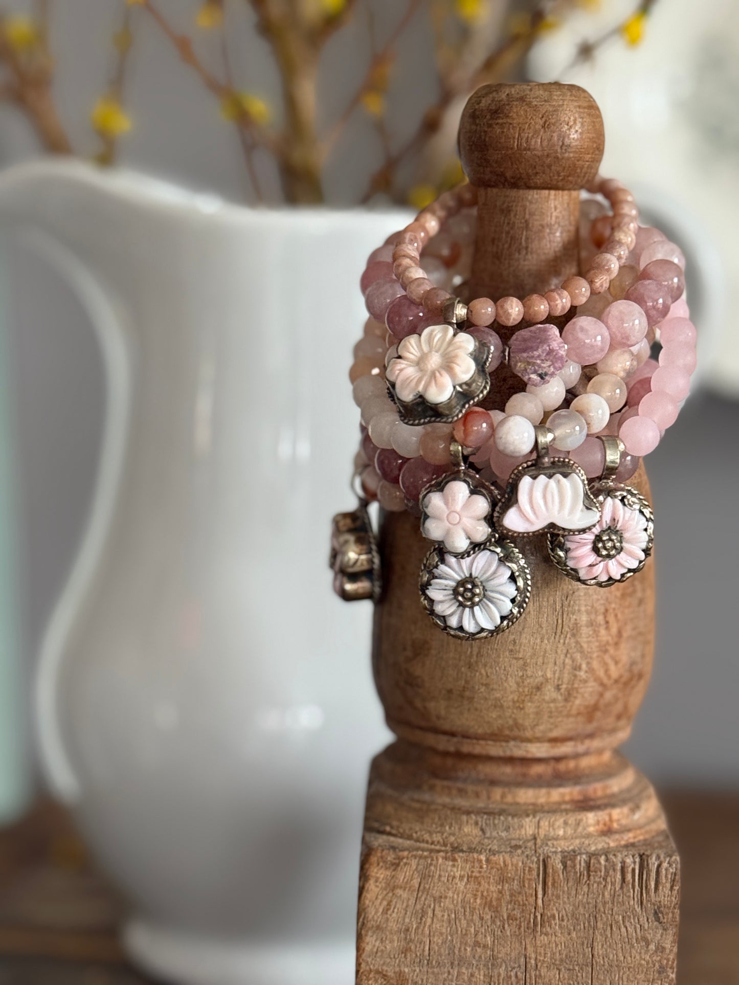 A rough cut, unpolished ruby sits among rose quartz beads in this pink stretch bracelet. 7.5”