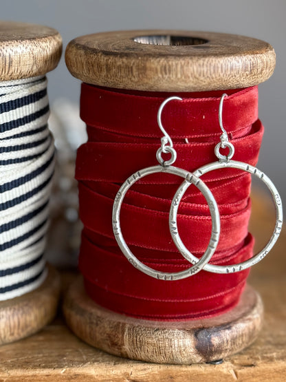 Stamped fine silver hoop earrings.