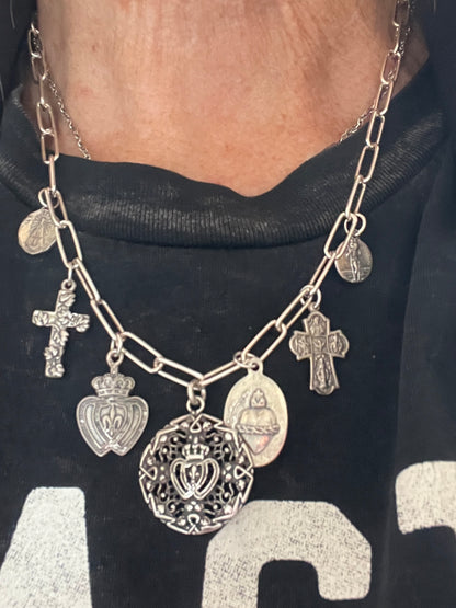 Aged sterling silver heart, cross, and saints medals on paperclip chain, sterling silver necklace. Adjustable to 18.5”.