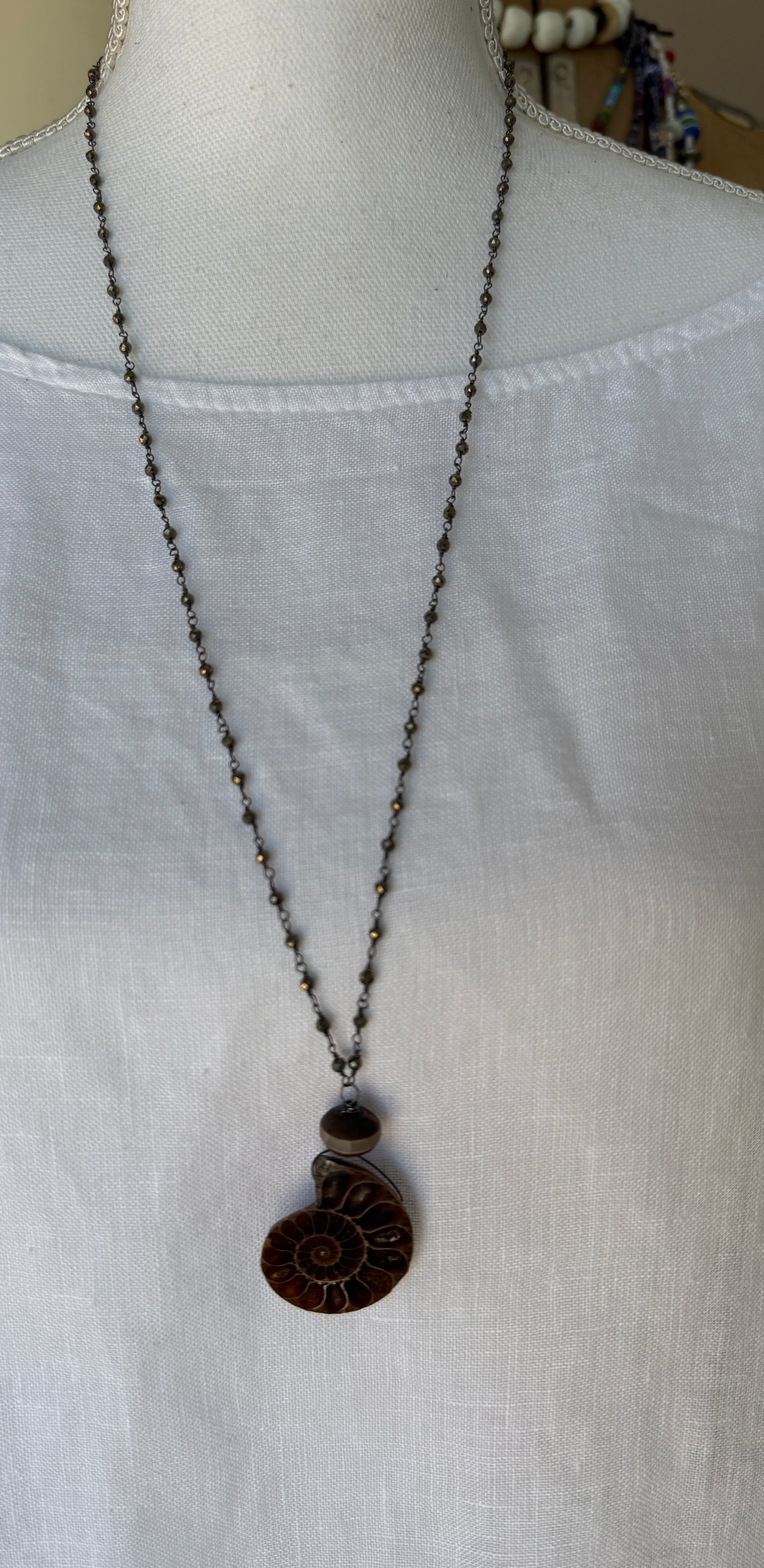 Natural ammonite fossil on pyrite chain necklace.