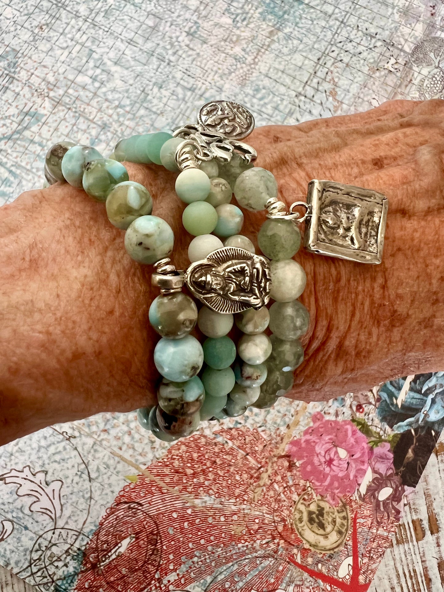 Bracelet of faceted aquamarines with a solid sterling silver sitting Buddha charm.