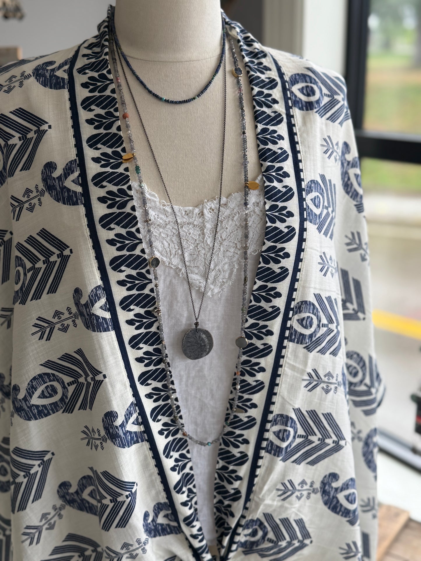 Extra long layering necklace/bracelet of pale iolite and assorted gems with vermeil and fine silver accents on adjustable deerskin leather. 50”