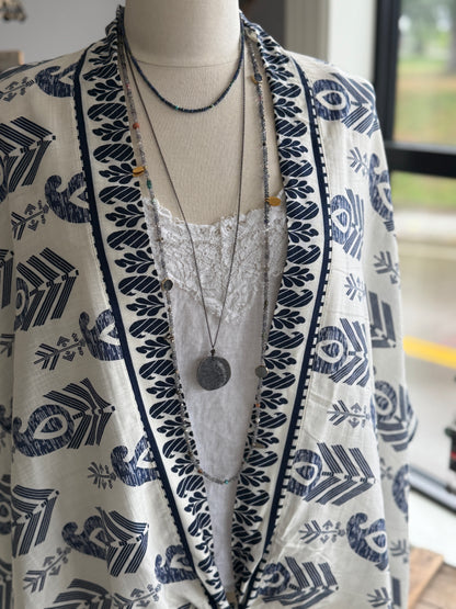 Extra long layering necklace/bracelet of pale iolite and assorted gems with vermeil and fine silver accents on adjustable deerskin leather. 50”