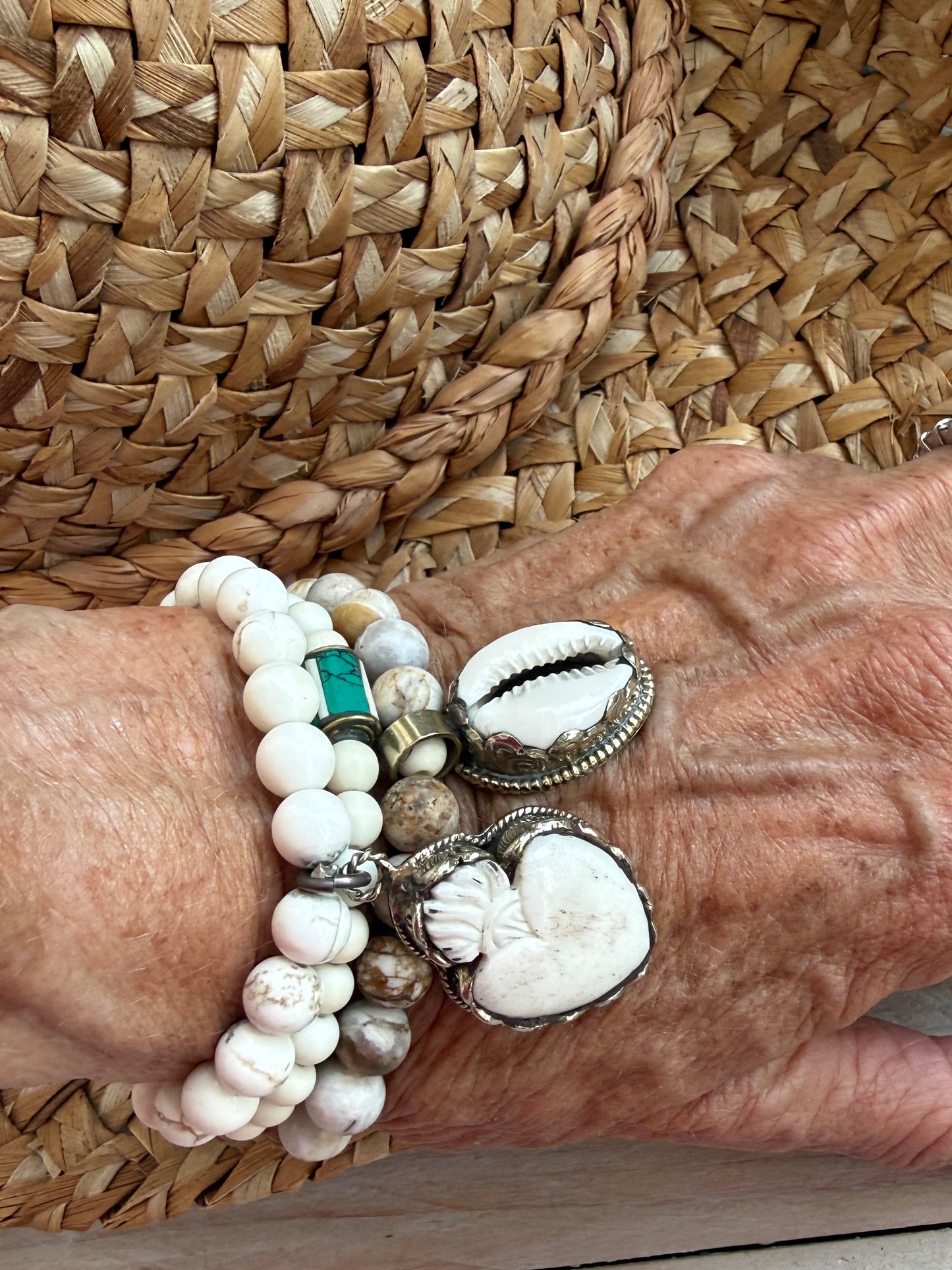 White riverstone stretch stack bracelet with turquoise and bone inlay bead from Nepal. 6.5”