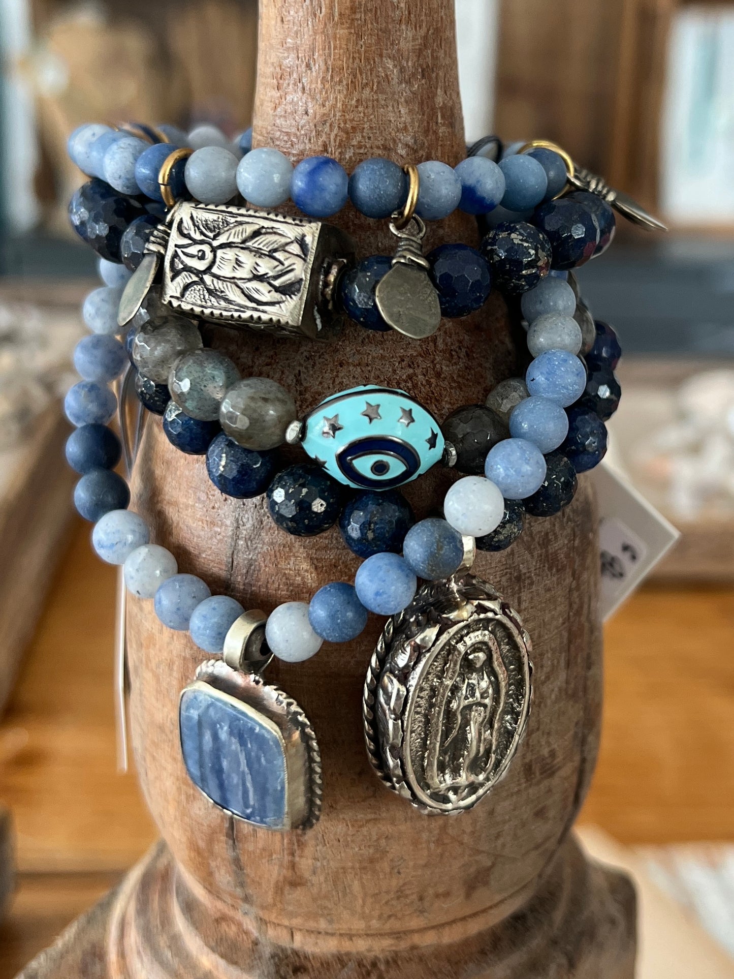 Tibetan blue kyanite pendant suspended from matte blue aventurine stack stretch bracelet. 7”