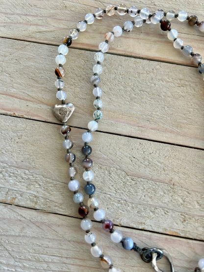 Pearl cross on knotted agates with fine silver heart accent. 44” necklace.