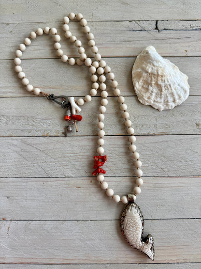 Tibetan carved bone fish on knotted riverstone and coral long necklace. Coral and fine silver fish charms.