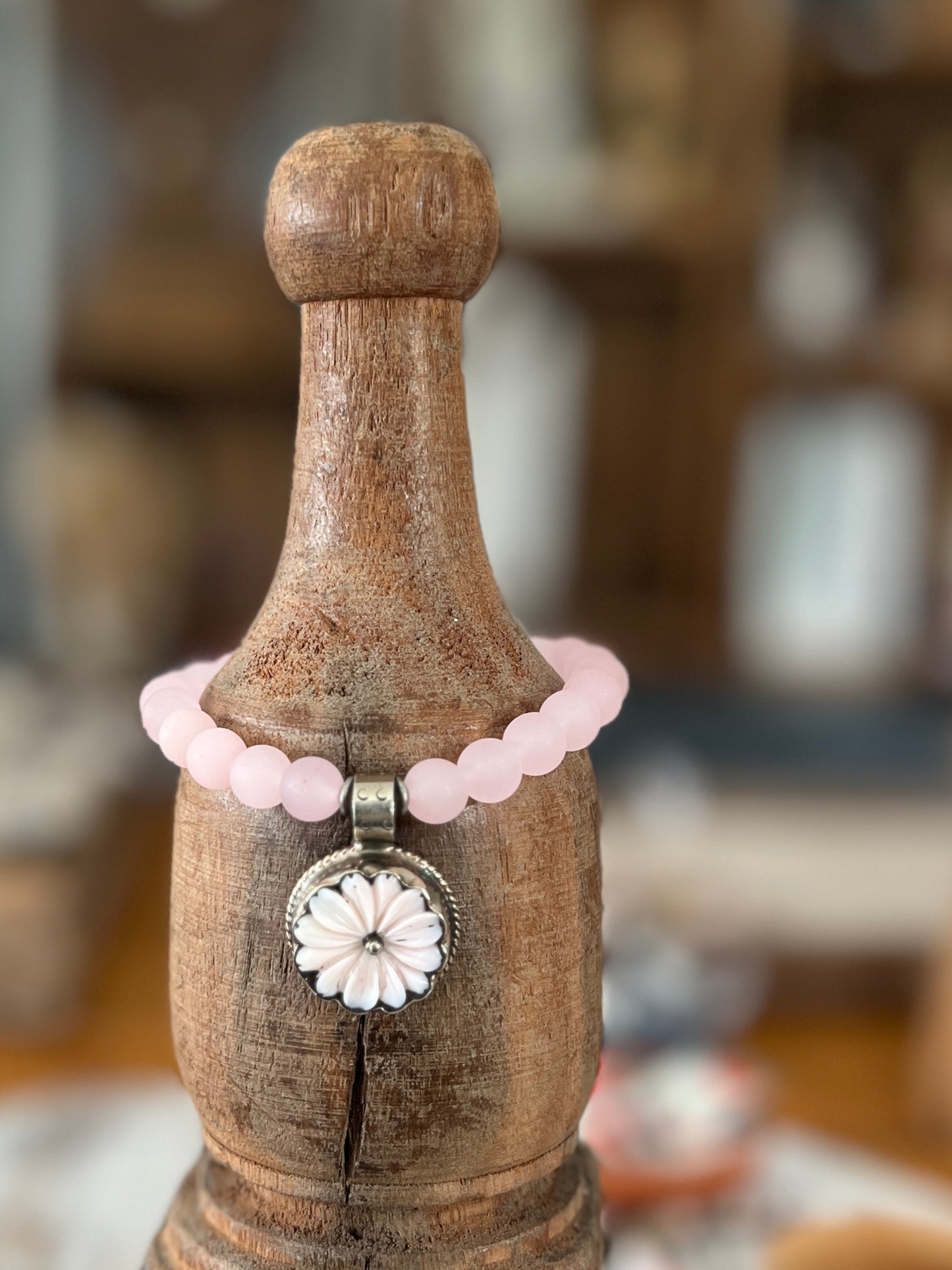 Pale pink Peruvian Opal carved flower from Tibet dangles from rose quartz. 7” stretch stack bracelet.