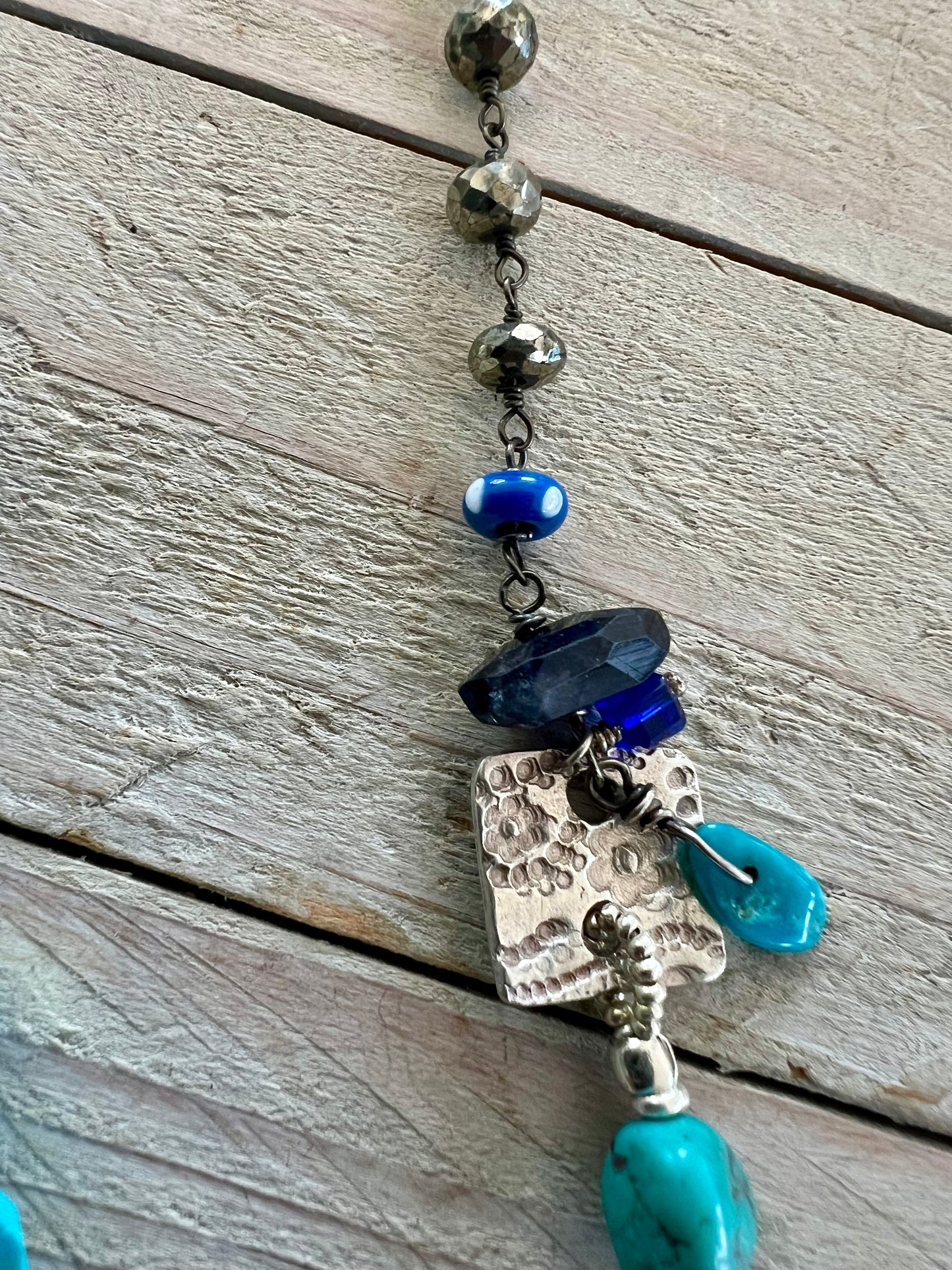 Sterling cross and heart pendant on a colorful assortment of gemstones. Adjustable necklace.