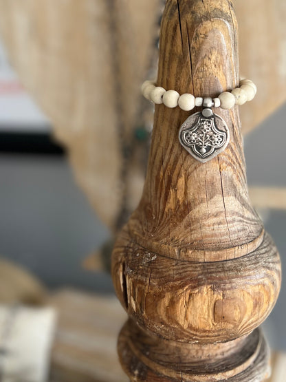 Old Tibetan sterling silver talisman on riverstone beads. Stack bracelet. 6-6.5”