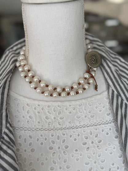 White pearls knotted on leather long necklace with removable tassel.