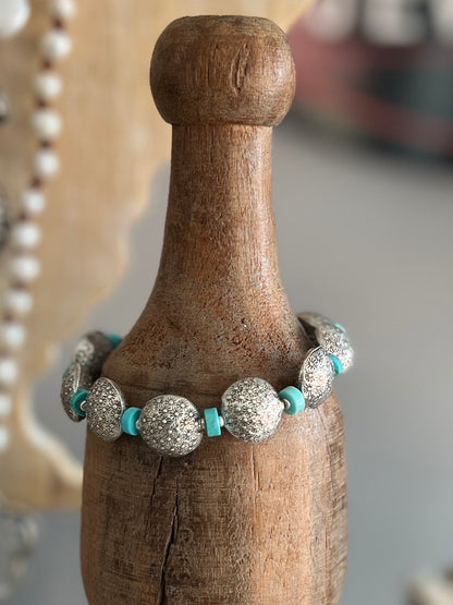 Stamped fine silver coins and turquoise bracelet. Adjustable 7-8”.