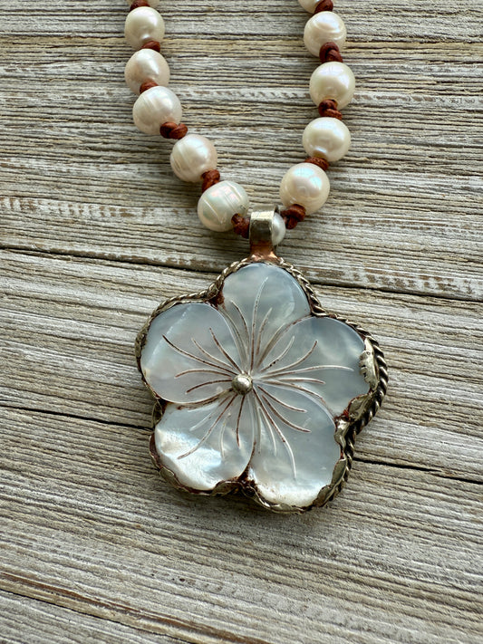 Tibetan repousé mother of pearl flower pendant on knotted pearls long necklace. Wear doubled or long. 32” long.