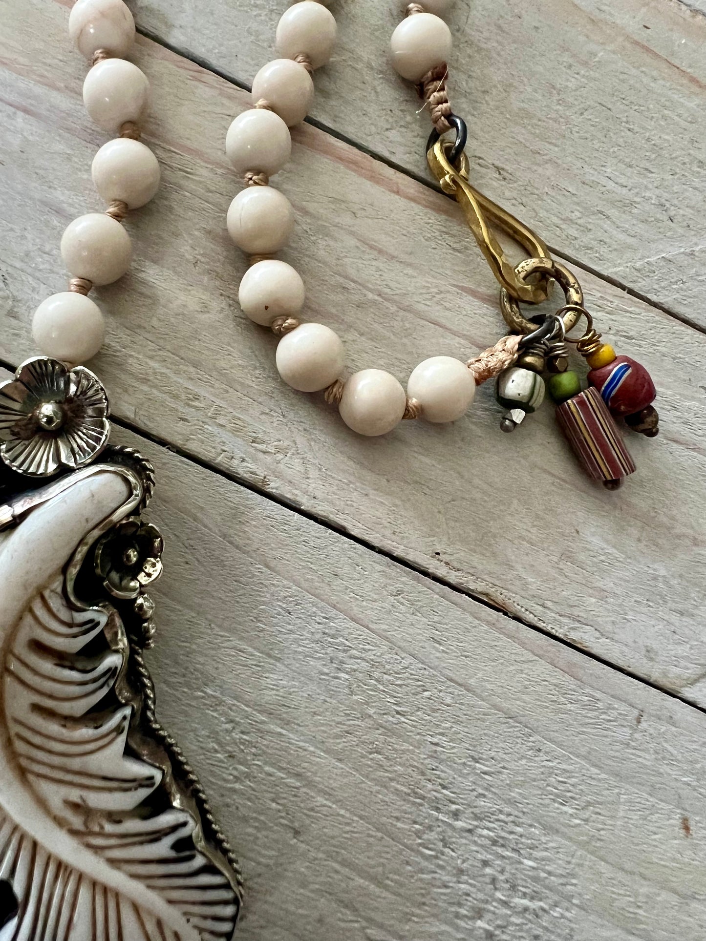 Bone feather on riverstone long boho necklace.