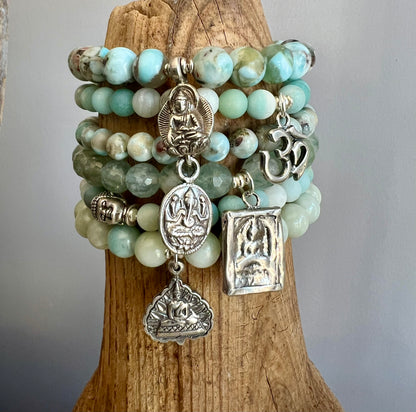 Bracelet of faceted aquamarines with a solid sterling silver sitting Buddha charm.