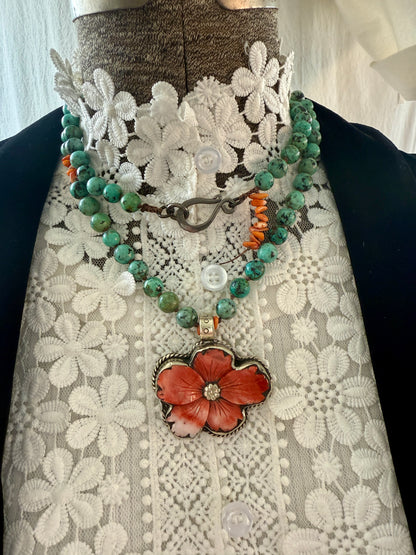 Spiny oyster flower pendant from Tibet on knotted turquoise with spiny oyster accents. 34” long necklace.