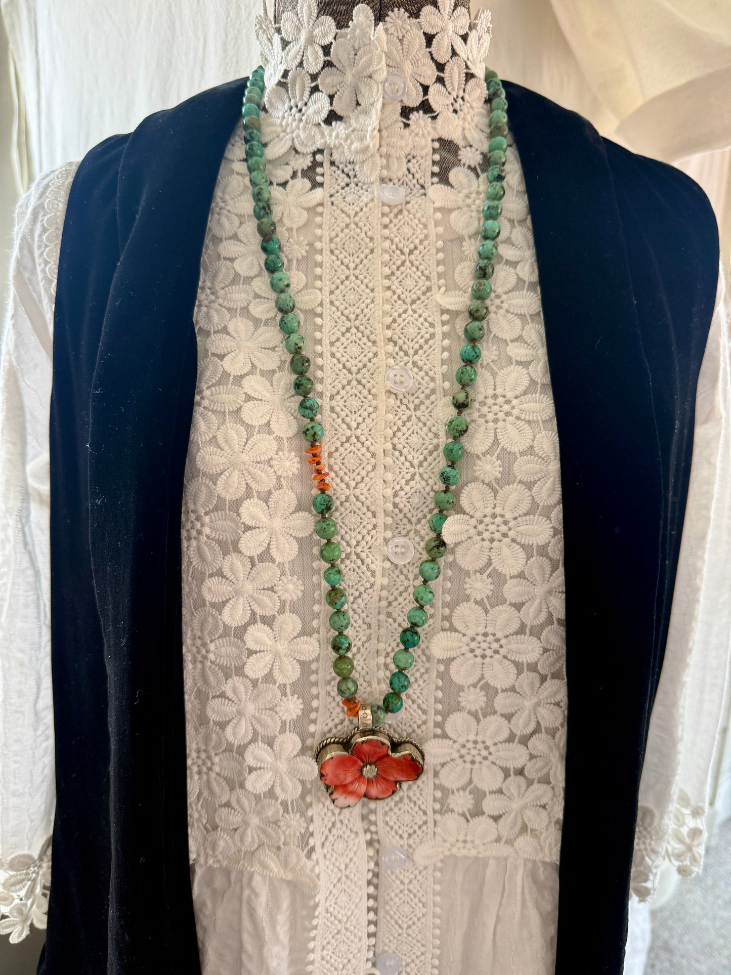 Spiny oyster flower pendant from Tibet on knotted turquoise with spiny oyster accents. 34” long necklace.