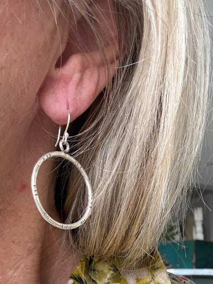 Stamped fine silver hoop earrings.