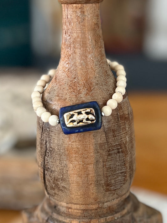 Lapis focal bead with a sterling gecko embedded riverstone stack stretch bracelet. 6-7”