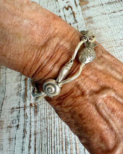 Fine silver sealife and shell bracelet with toggle clasp. 7”.