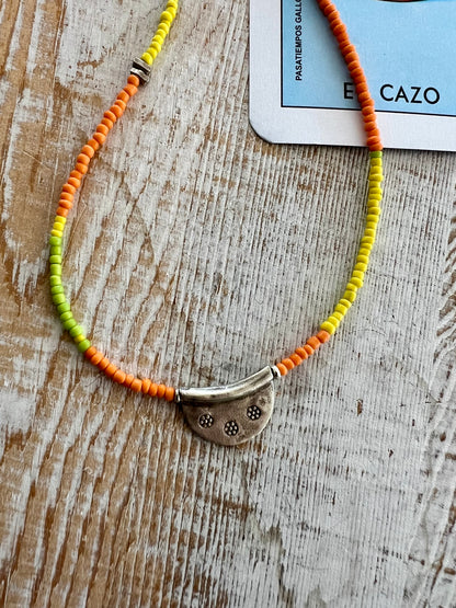 Citrus mix seed beads from Java dance around a stamped Thai half moon. So cute on its own or when layered up with other ladeDAH! pieces.