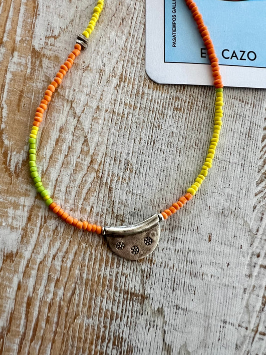 Citrus mix seed beads from Java dance around a stamped Thai half moon. So cute on its own or when layered up with other ladeDAH! pieces.