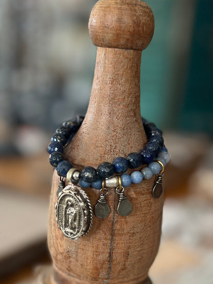 Faceted lapis beads surround a beautiful Tibetan repousé Mary. Stretch stacker bracelet 6-6.5”