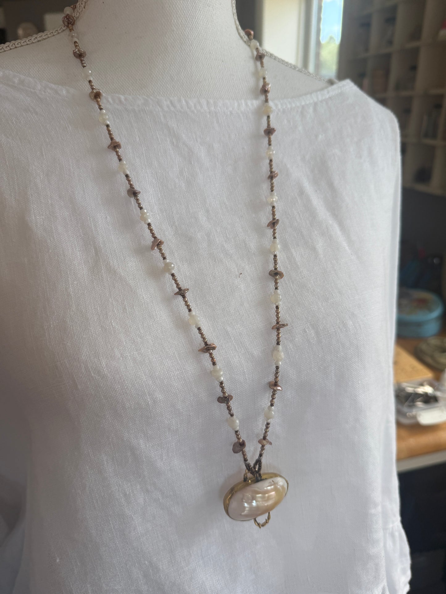 A vintage handcrafted shell ring box pendant with champagne pearls and moonstone long necklace.